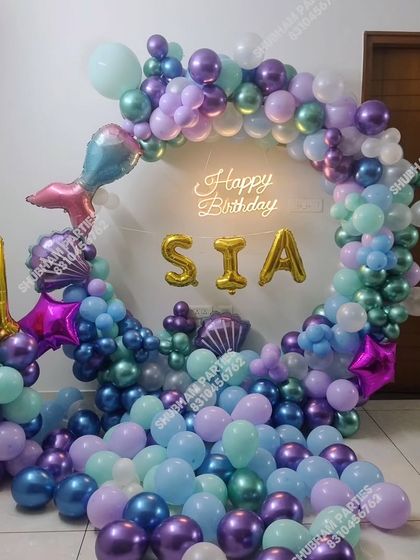 A closer look at the mermaid theme, with a number "1" foil balloon and name display.