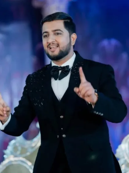 The groom commanding the stage at his reception. The makeup ensures his features are defined and he looks great under the stage lights.