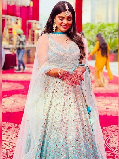 A beautiful light blue lehenga with delicate floral embroidery. This is a perfect daytime event outfit, ideal for a mehendi or Anand Karaj ceremony.