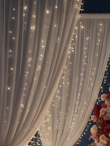 Simple yet effective, this image shows how I use curtains of fairy lights behind sheer white drapes. This technique creates a soft, twinkling backdrop that adds a magical and romantic ambiance to any space.