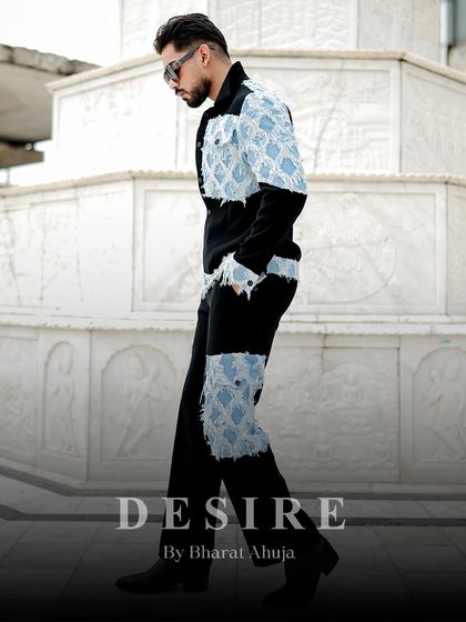 A side view of the complete denim patchwork outfit, showing the placement of the patches on both the jacket and trousers for a cohesive, statement look.