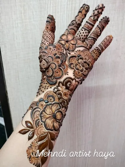 This full-arm design is a floral masterpiece, with different types of flowers and leaves creating a dense, garden-like pattern.