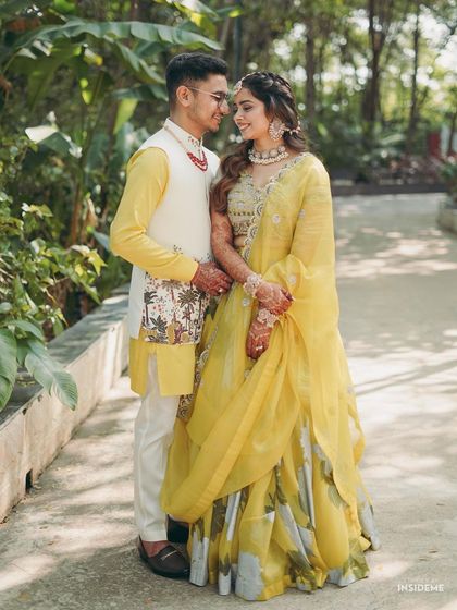 A classic portrait of the couple amidst lush greenery. The bride's makeup is perfectly balanced, enhancing her features while looking completely natural.