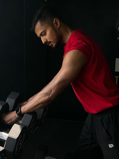 True enjoyment comes from the activity of the mind and exercise of the body. Here, I'm selecting dumbbells for a bicep curl, a classic isolation exercise to build arm strength and definition.