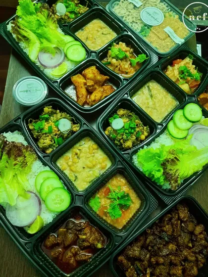 A display of my best-selling thalis from 2023. You can see the variety I offer, from pork stir-fry to different dals and vegetable dishes.