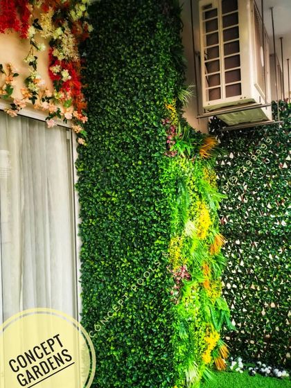 This image shows how we expertly work around existing structures like air conditioning units, integrating them seamlessly into the green wall design.