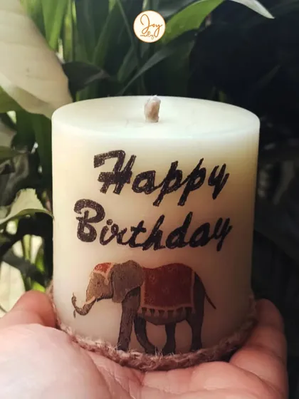 A custom "Happy Birthday" pillar candle with an elephant design. I love creating these personalized candles for clients to stock up on for their friends' birthdays.