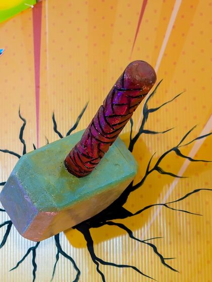 A prop of Thor's hammer, Mjolnir, embedded in a cracked wall, is another detail that brings the Avengers theme to life.