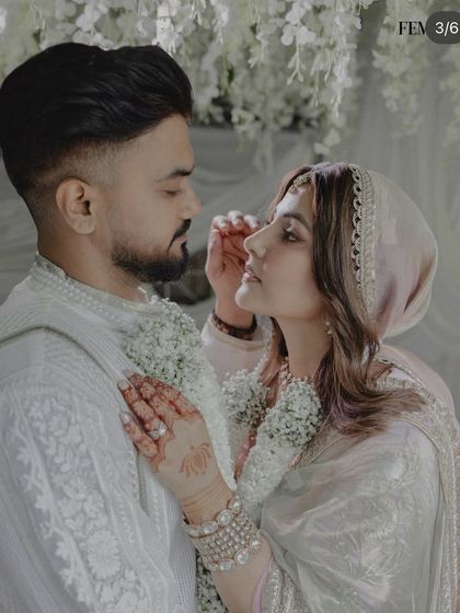 A close-up shot featured in Femina, focusing on the couple's intimate gaze and the delicate details of their attire, all framed by our soft floral decor.