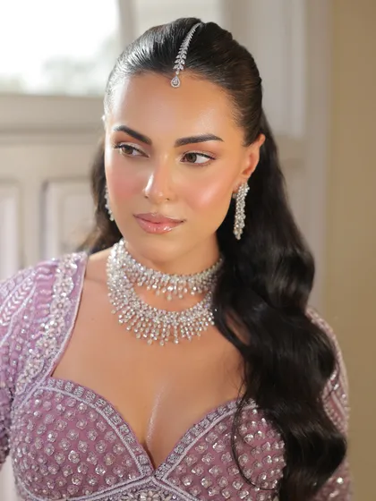Another beautiful close-up, capturing the sparkle of the diamond necklace and the intricate beadwork on the lavender blouse.