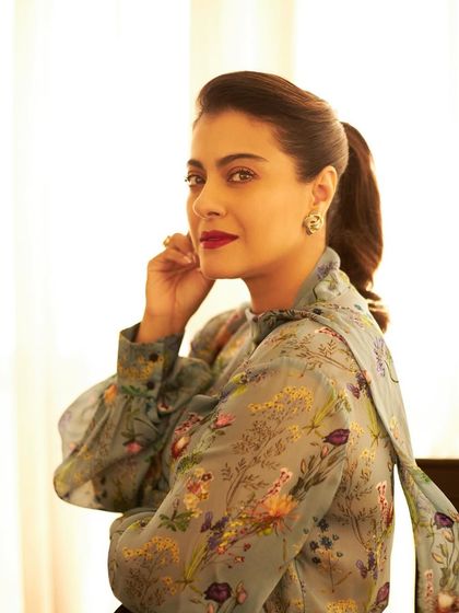 A classic portrait pose that highlights the vintage Chanel earrings and the bold red lip.