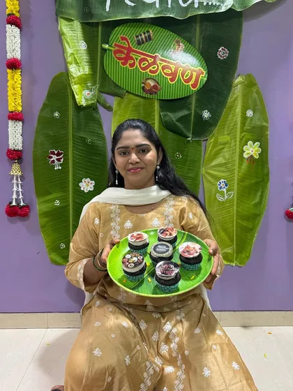 A happy client with her plate of custom Kelvan cupcakes, ready for the celebration.