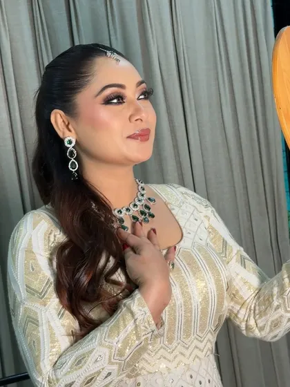 A beautiful candid moment of the bride admiring her Nikkah look in the mirror. The soft lighting highlights her radiant skin and defined eyes.