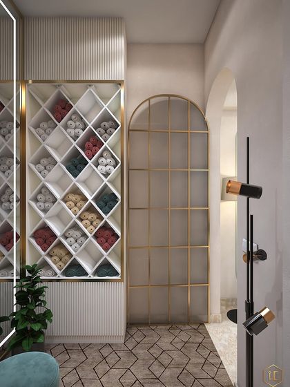 A finely crafted walk-in space with a dedicated area for storing towels or linens. The arched glass door provides a beautiful view into the adjoining room.