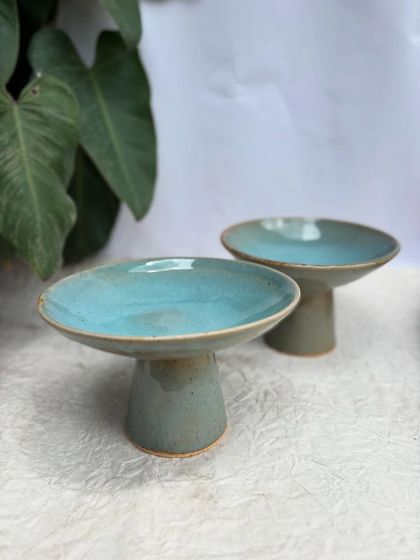 We've been experimenting with new forms, like these elevated plates or shallow bowls. They're perfect for serving desserts, appetizers, or as a beautiful centerpiece.