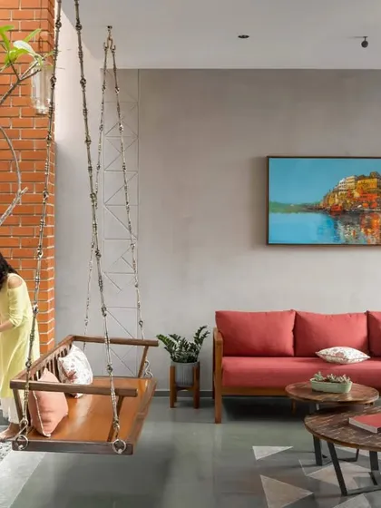 A quiet moment in the 'Screen House'. The indoor swing sits beside a small, sunlit courtyard, bringing a sense of calm and nature right into the living space. It’s these small, thoughtful nooks that make a house feel like a home.