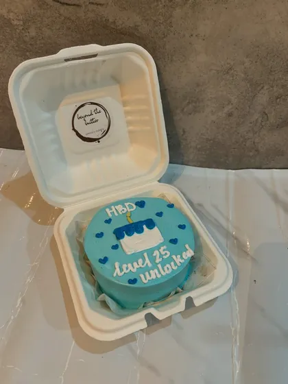 A fun bento cake for a 25th birthday celebration, with the message "HBD Level 25 unlocked" and a little cake illustration.