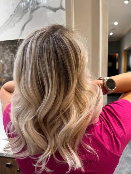 A pearl blond hair colour balayage with soft, cool tones and a beautiful shine.