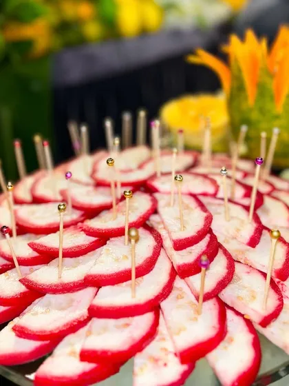 Slices of sweet red guava, arranged beautifully on a platter. This simple yet elegant presentation highlights the natural beauty and freshness of the fruit.