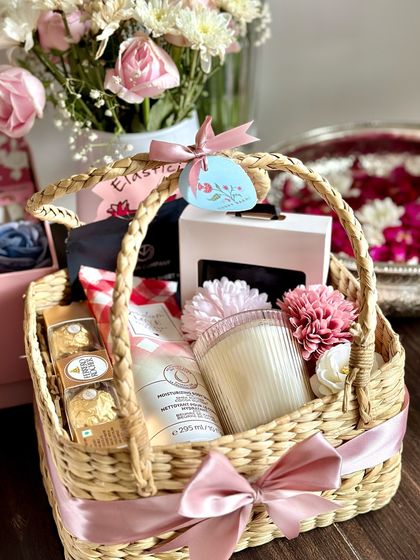 A pampering Rakhi hamper for your Bhaiya and Bhabhi. This basket contains a Zara men's wallet, Bath & Body Works shower gel, face sheet masks, a scented candle, and Ferrero Rocher.