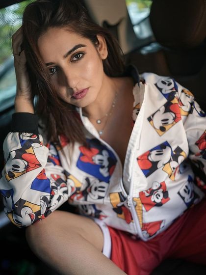 A close-up from the in-car series, focusing on the model's direct gaze. This shot is edited to have warm, rich tones, giving it a vibrant and engaging feel.