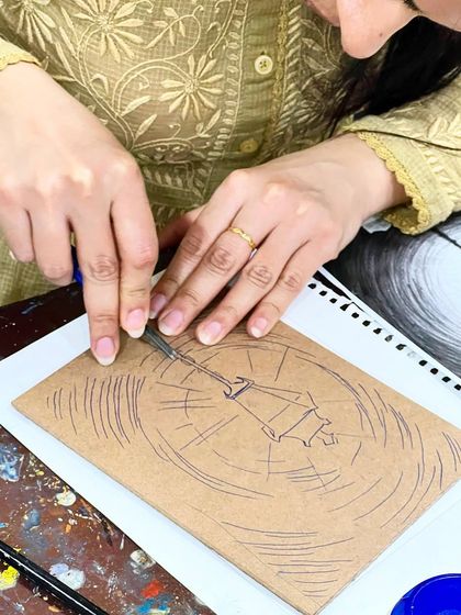 A student meticulously carving a lamppost design into a linoleum block, creating fine lines for the light rays.