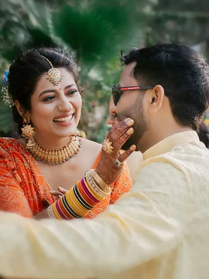 A beautiful, candid moment from a Haldi ceremony, where the bride lovingly touches the groom's face. Their smiles speak volumes.