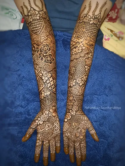 Sanaya's full bridal henna, featuring a mix of checkerboard patterns, floral elements, and traditional Indian motifs.