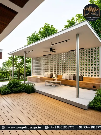 A bright and airy patio design featuring a white pergola with a jali-inspired back wall. The open-air design, combined with comfortable bench seating and a ceiling fan, creates a perfect shaded spot for hot days.