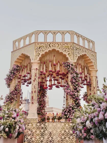 A full view of the exquisite mandap, showcasing its intricate design and the abundance of fresh flowers that create a setting of pure opulence.