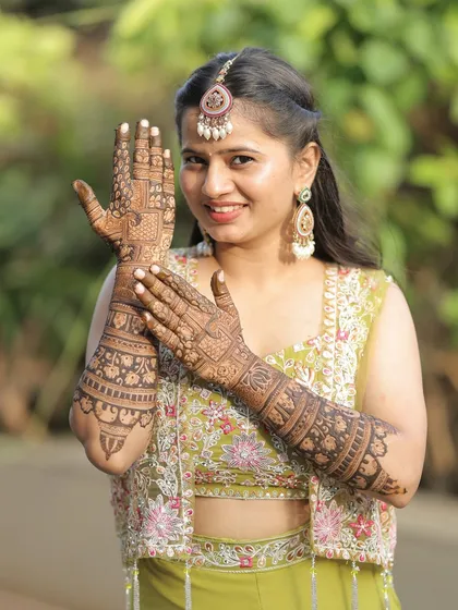 The bride proudly displaying her bridal mehendi. It was an honor to create this design for her special day.