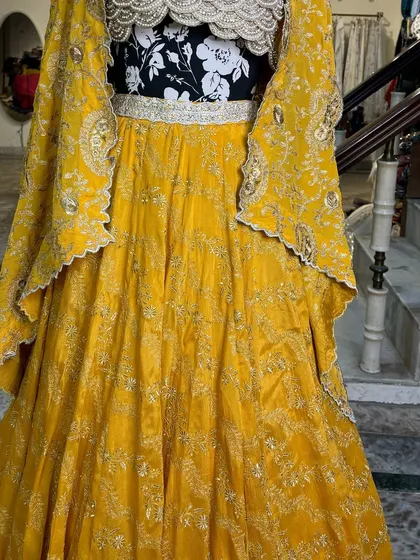 The lehenga comes with a beautiful cape-style dupatta with matching embroidery, making it a complete and regal outfit.