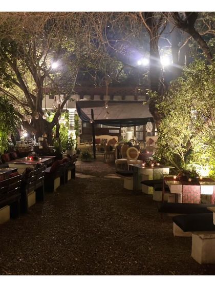 A wide view of the beautiful outdoor seating at the Garden of Five Senses. Our service extends to managing the dining experience in unique and sprawling venues, ensuring every corner feels special.