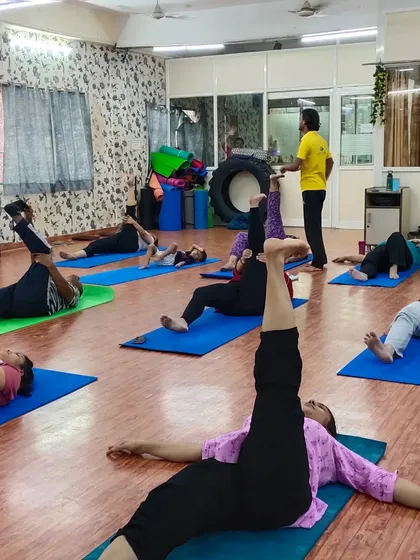 Our students working on their leg flexibility. An instructor is seen guiding them, ensuring they practice safely and effectively to improve their range of motion.