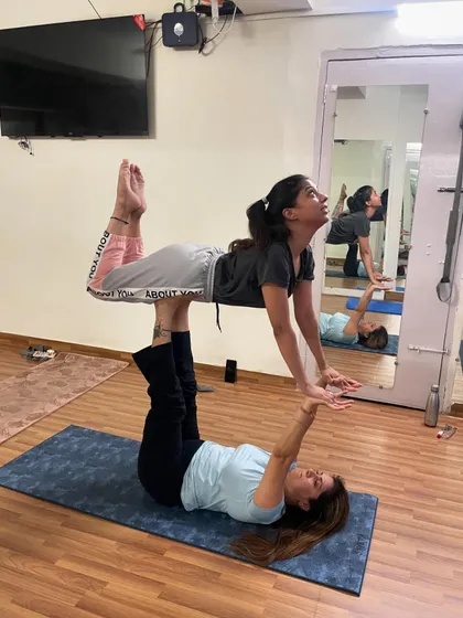 This is a foundational acroyoga pose that we build towards. Here, the base provides a solid platform with their legs, while the flyer learns to engage their core and trust their partner for balance. It is a powerful way to build strength and connection.
