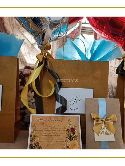 Surprise gift bags for a first anniversary, complete with heart-shaped balloons and personalized notes.