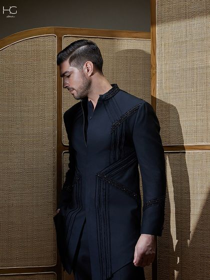 A profile view of the embroidered achkan, emphasizing its sharp, clean lines and the way the intricate details draw the eye.