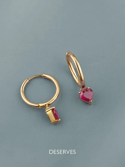 These earrings reflect the glimmer in her eyes. A perfect gift for Mother's Day, these custom ruby hoops come in two styles, one with a heart and one with a baguette, to show your love and affection.