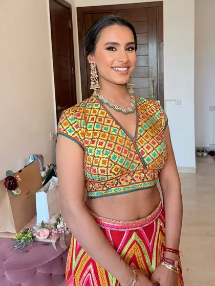 Meher's smile and radiant bronze glam are a perfect match for her colorful Abu Jani Sandeep Khosla outfit.