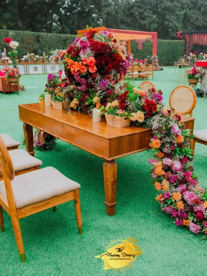 I love creating statement floral runners that cascade dramatically off the table. This piece brings so much life and colour to the outdoor dining setup.