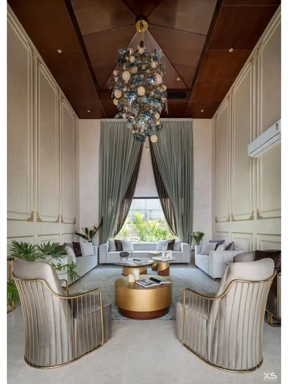 For this luxury villa, we designed a double height living room that balances grandeur with a cozy, inviting feel. The statement chandelier from Klove Studio acts as a centerpiece, while the subtle tones and plush furniture create a space of royal comfort.
