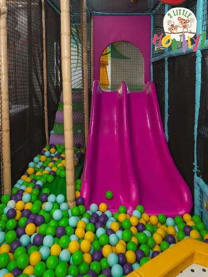 A double slide means double the fun! This bright pink slide lands right in our colorful ball pit, filled with thousands of soft, clean balls. It's one of the most popular spots in our entire play area.