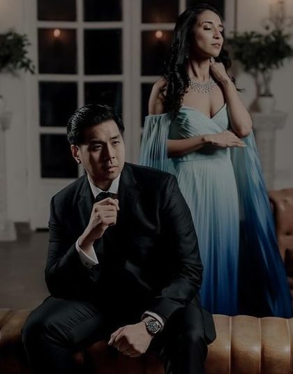 A sophisticated and elegant pose. The makeup is chic and modern, fitting the high-fashion vibe of this pre-wedding shoot.