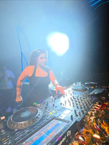 A wide view of my setup at a private party, showing the powerful backlighting and my Pioneer DJ equipment.