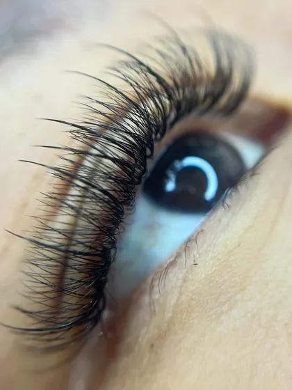 Here is an extreme close-up of my work. Notice how each individual extension is meticulously applied to create a dense, feathery look. I use high-quality human hair lashes that are lightweight and comfortable to wear.