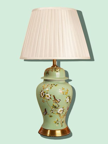 The soft, sage green of this ceramic lamp base is both calming and sophisticated. Hand-painted floral details add an artistic touch, making it a beautiful decorative piece for any surface.