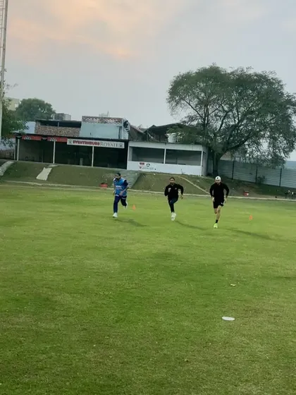 Group running session on the field. Training with other dedicated athletes builds camaraderie and pushes everyone to maintain a high standard of effort and conditioning.