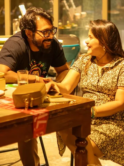 A candid moment between a couple, sharing a smile during the jam. It's a perfect spot for a relaxed and musical date.