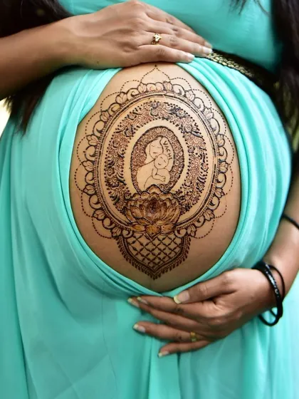 A special blessing for the mom to be. This pregnancy belly henna features a mother and child silhouette inside an intricate mandala frame, created with my all natural, organic paste that is completely safe for you and your baby.