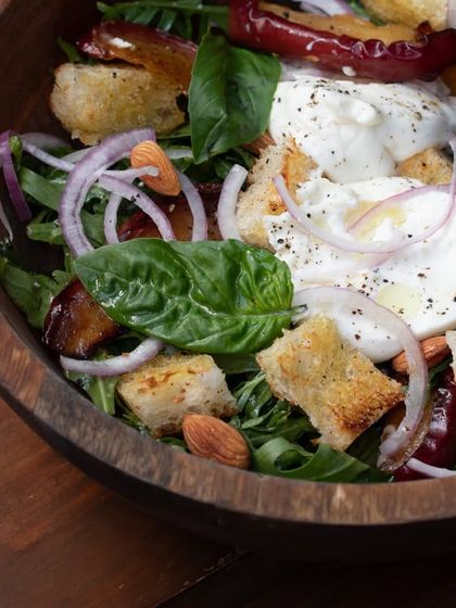 A closer look at our Panzanella salad, highlighting the combination of textures from the crunchy croutons, soft cheese, and fresh greens.